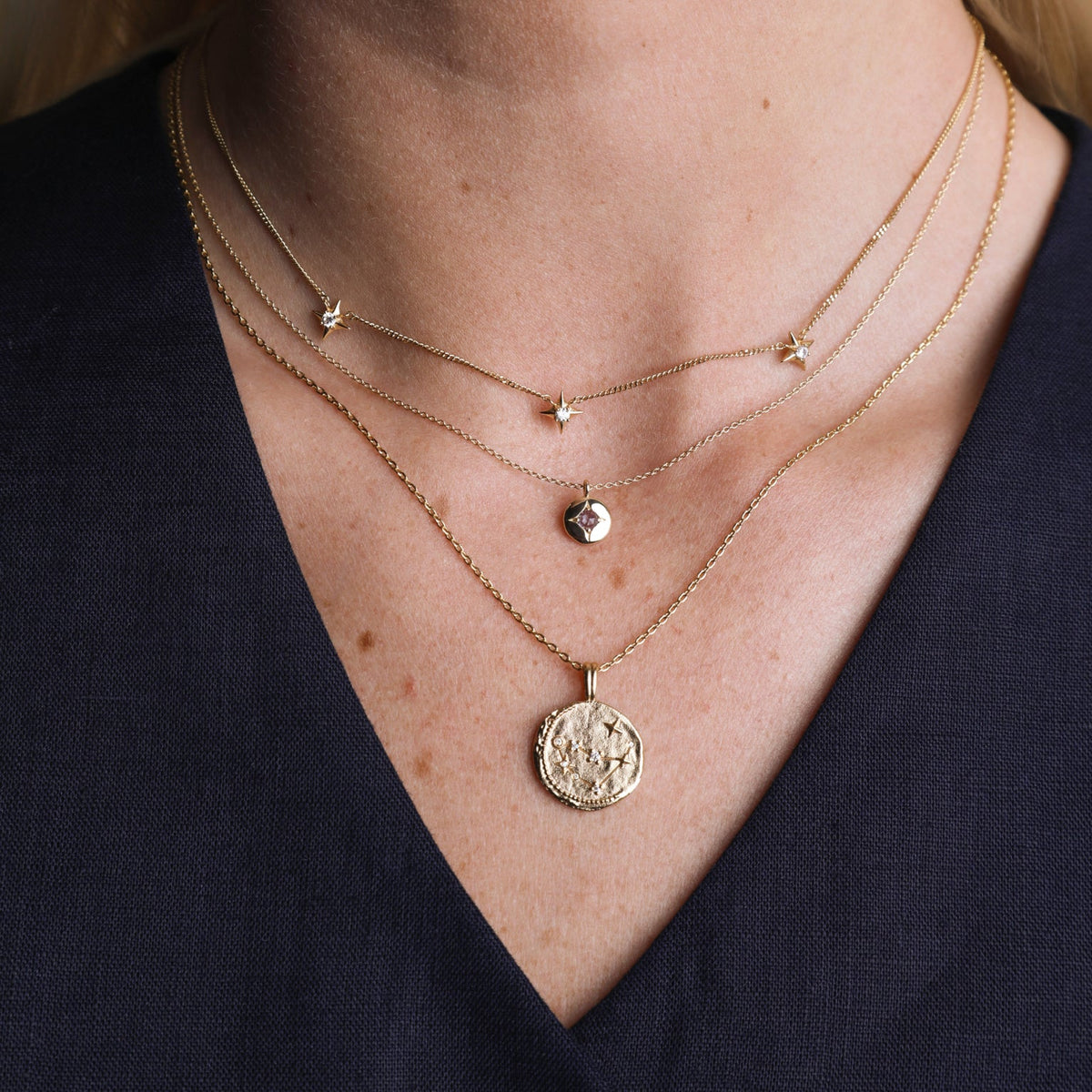 Woman wearing a minimalist silver snake chain with a silver necklace pendant for a simple yet elegant look.