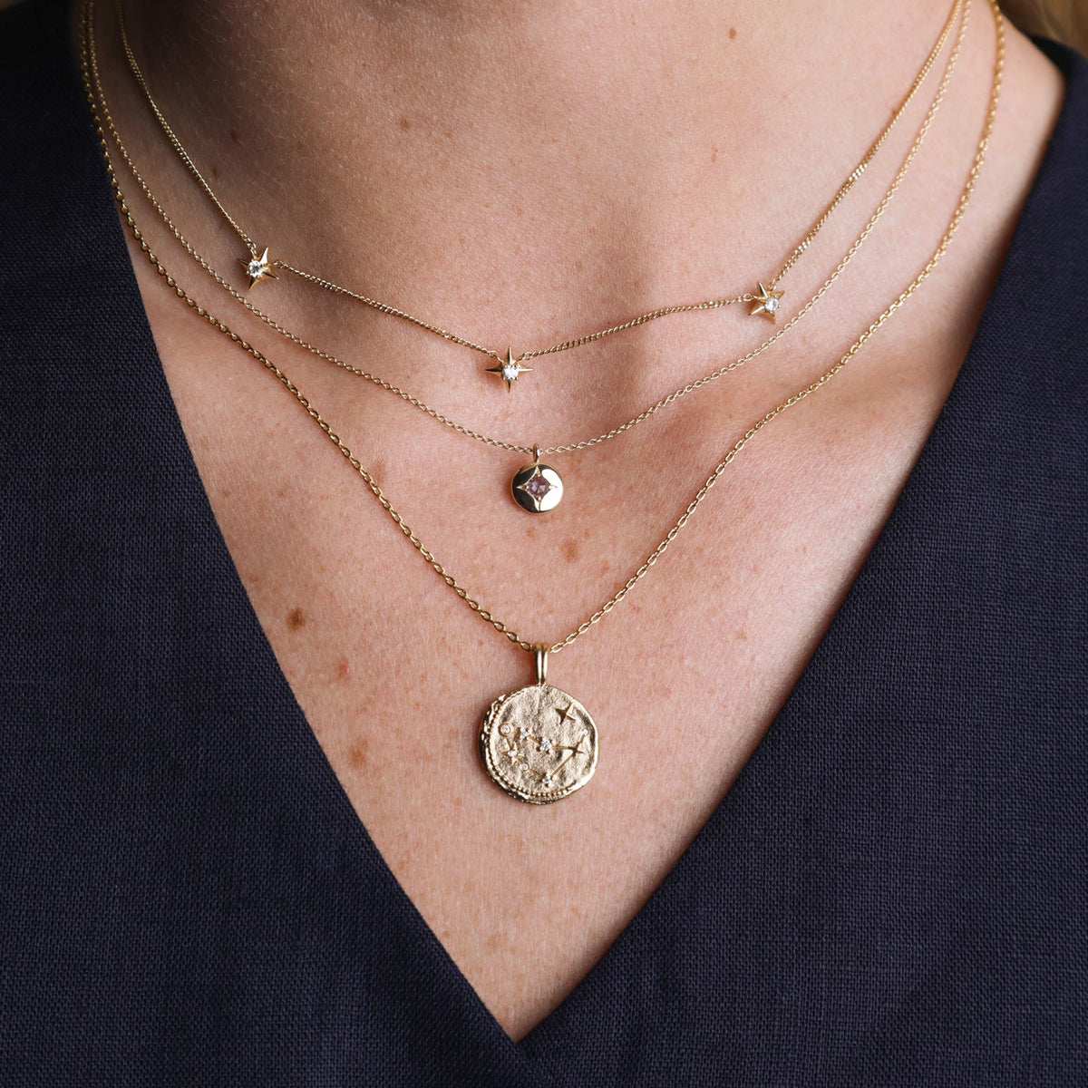Woman wearing a minimalist silver snake chain with a silver necklace pendant for a simple yet elegant look.