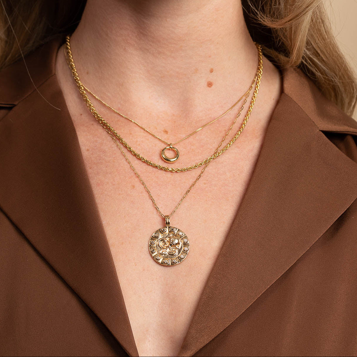 Bold Zodiac Aquarius Pendant Necklace in Gold worn layered with rope chain necklace and bold halo necklace