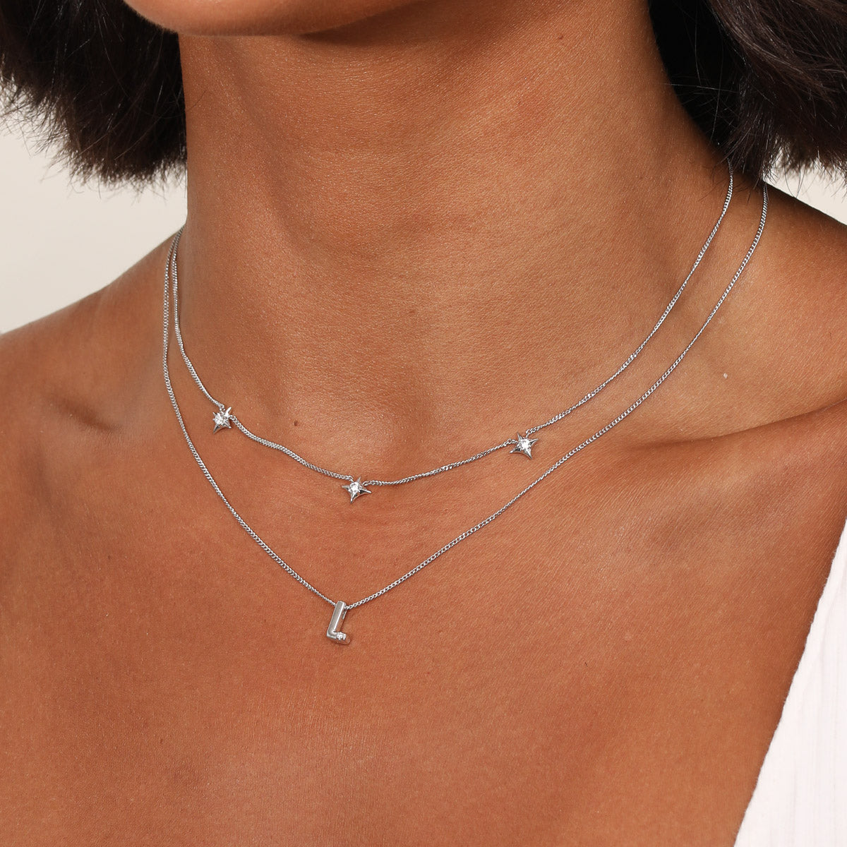 Cosmic Star Charm Necklace in Silver worn with an Initial Pendant Necklace in Silver