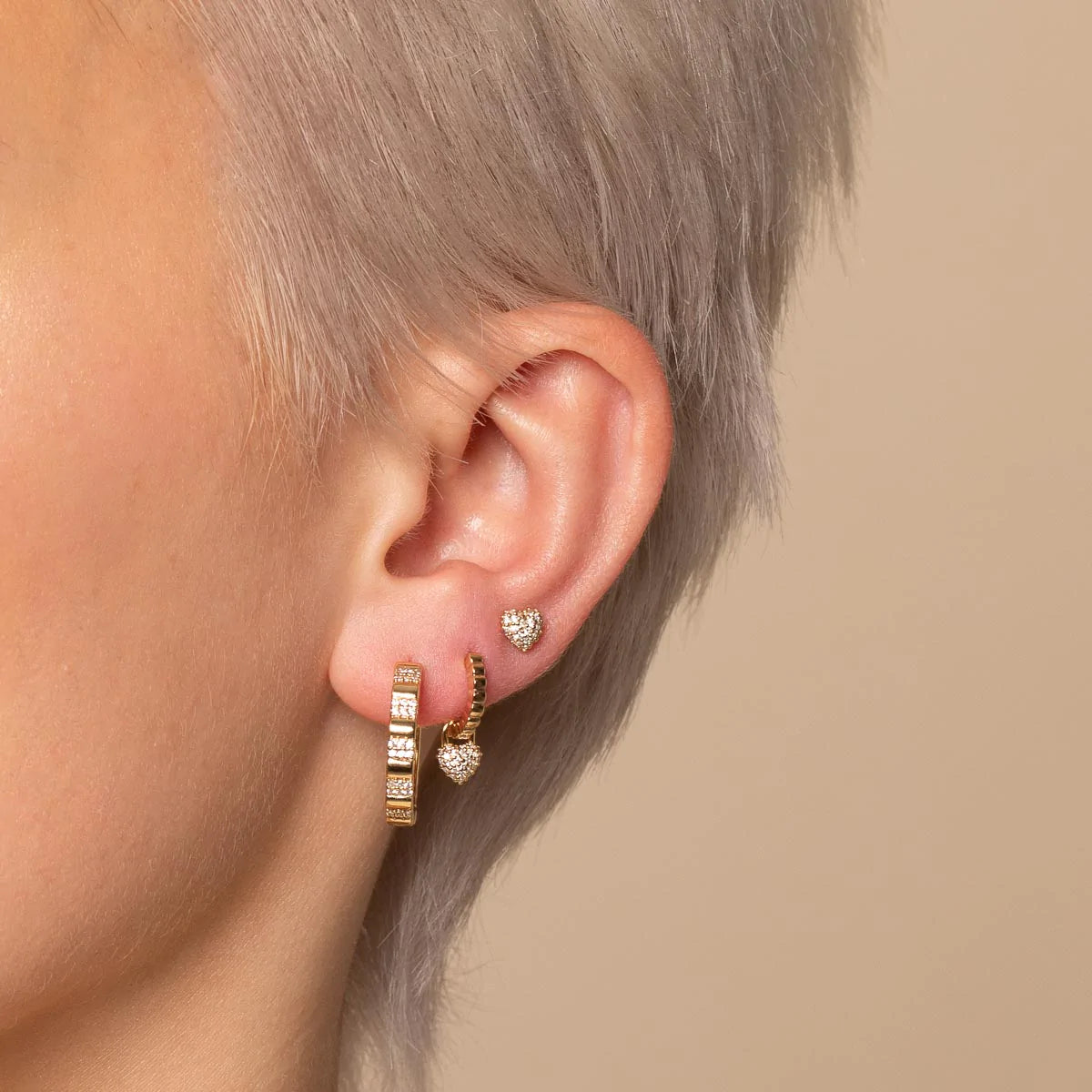 Heart Pave Charm Huggies in Gold worn with other earrings