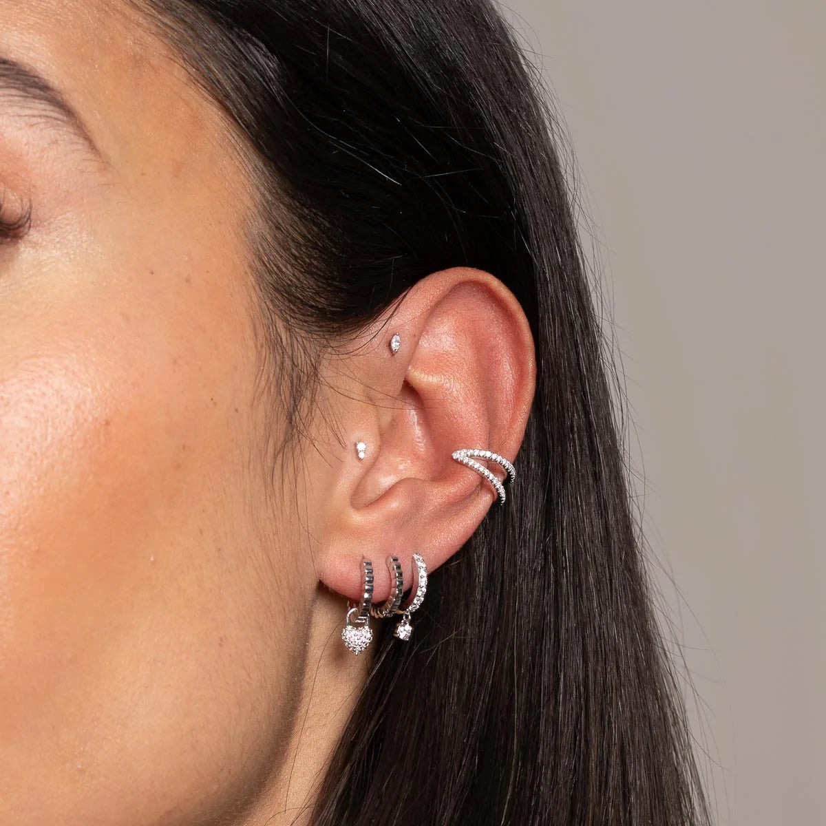 Heart Pave Charm Huggies in Silver worn with other earrings