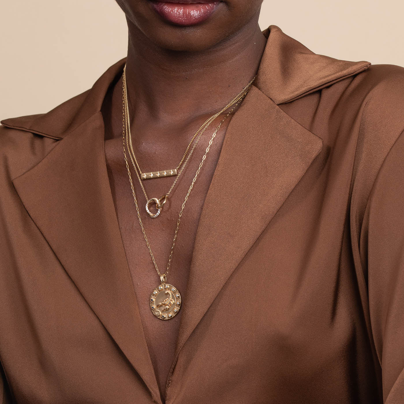 Scorpio Bold Zodiac Pendant Necklace in Gold worn layered with necklaces