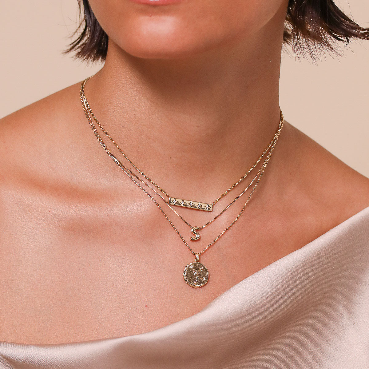Cancer Zodiac Pendant Necklace in Gold worn layered with necklaces
