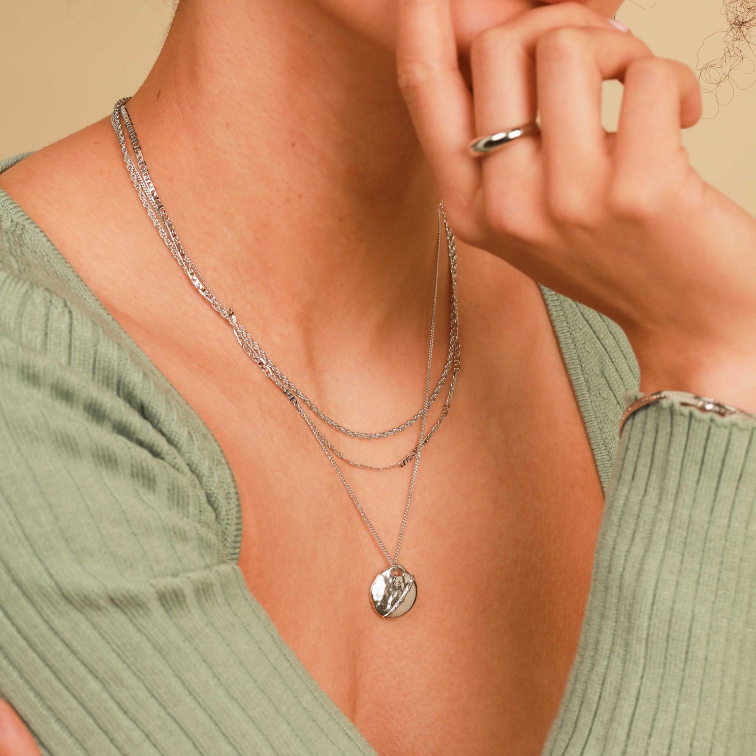Worn shot of Molten Coin Pendant Necklace in Silver
