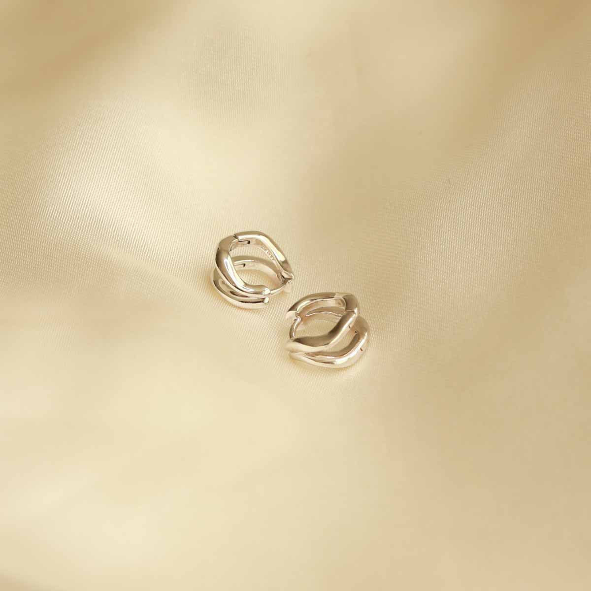 Flat lay shot of Molten Duo Huggies in Silver