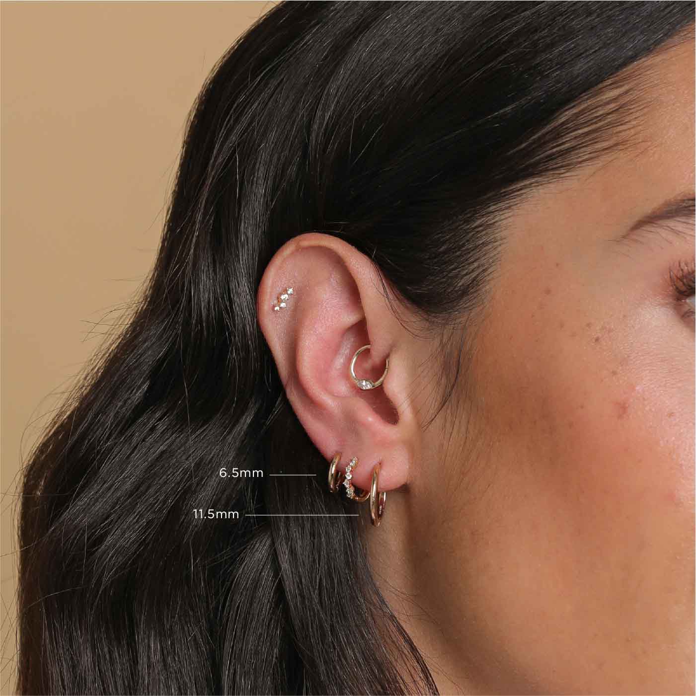 Essential 11.5mm Hoop in Gold worn in lobe piercing