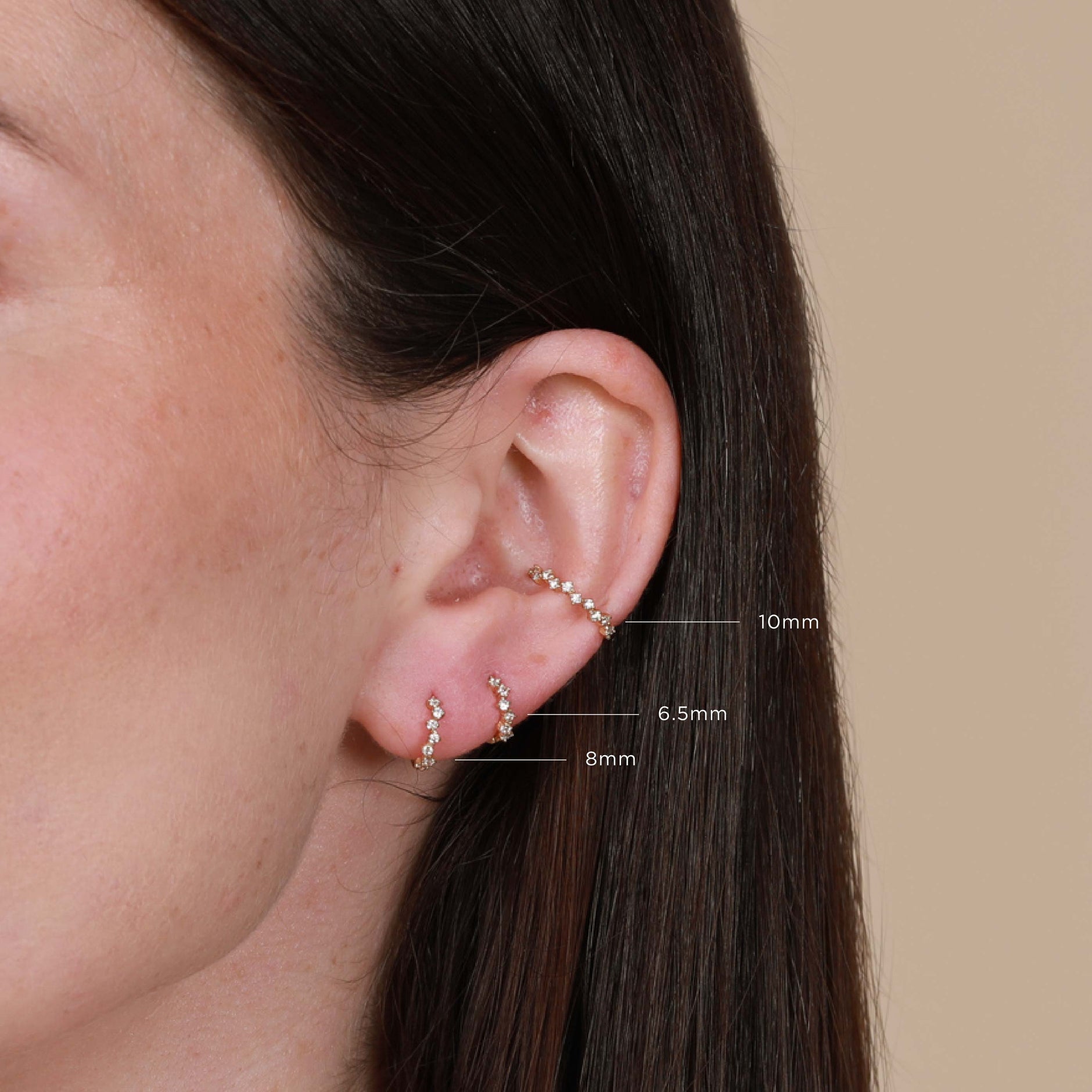 Worn shot of Cluster Hoop 11.5mm in Gold with sizes labelled