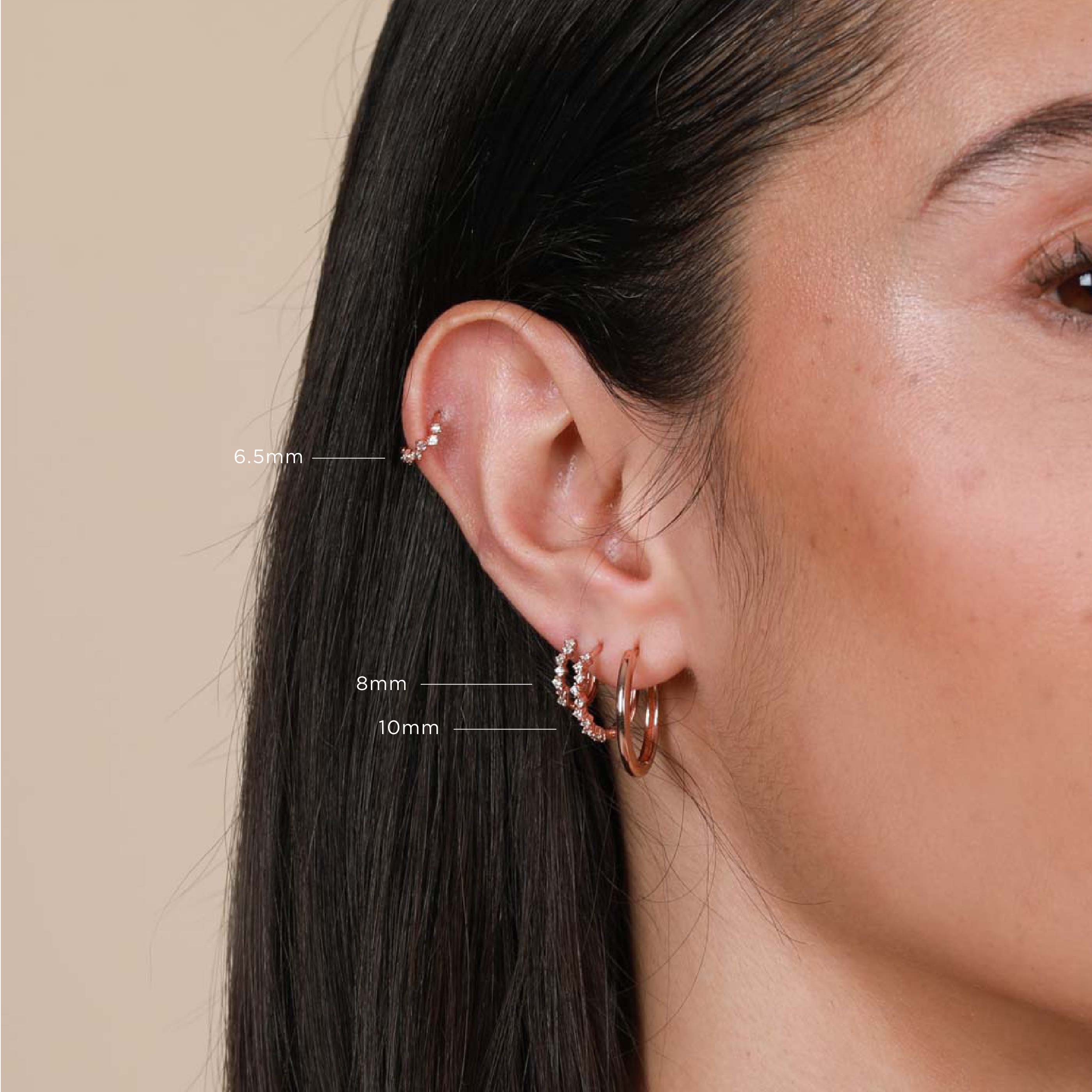 Worn shot of Cluster Hoop 8mm in Rose Gold with sizes labelled