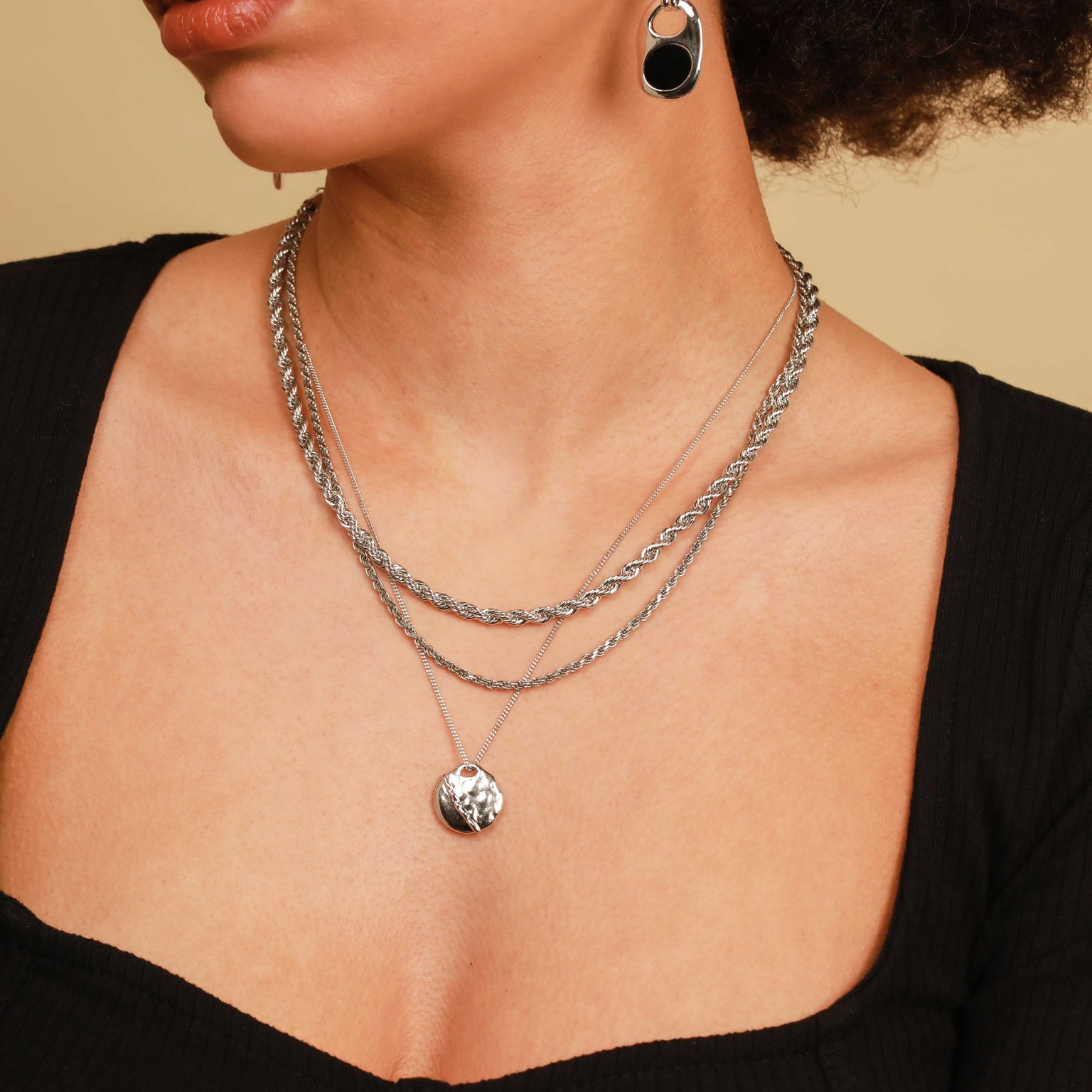 Worn shot of Molten Coin Pendant Necklace in Silver