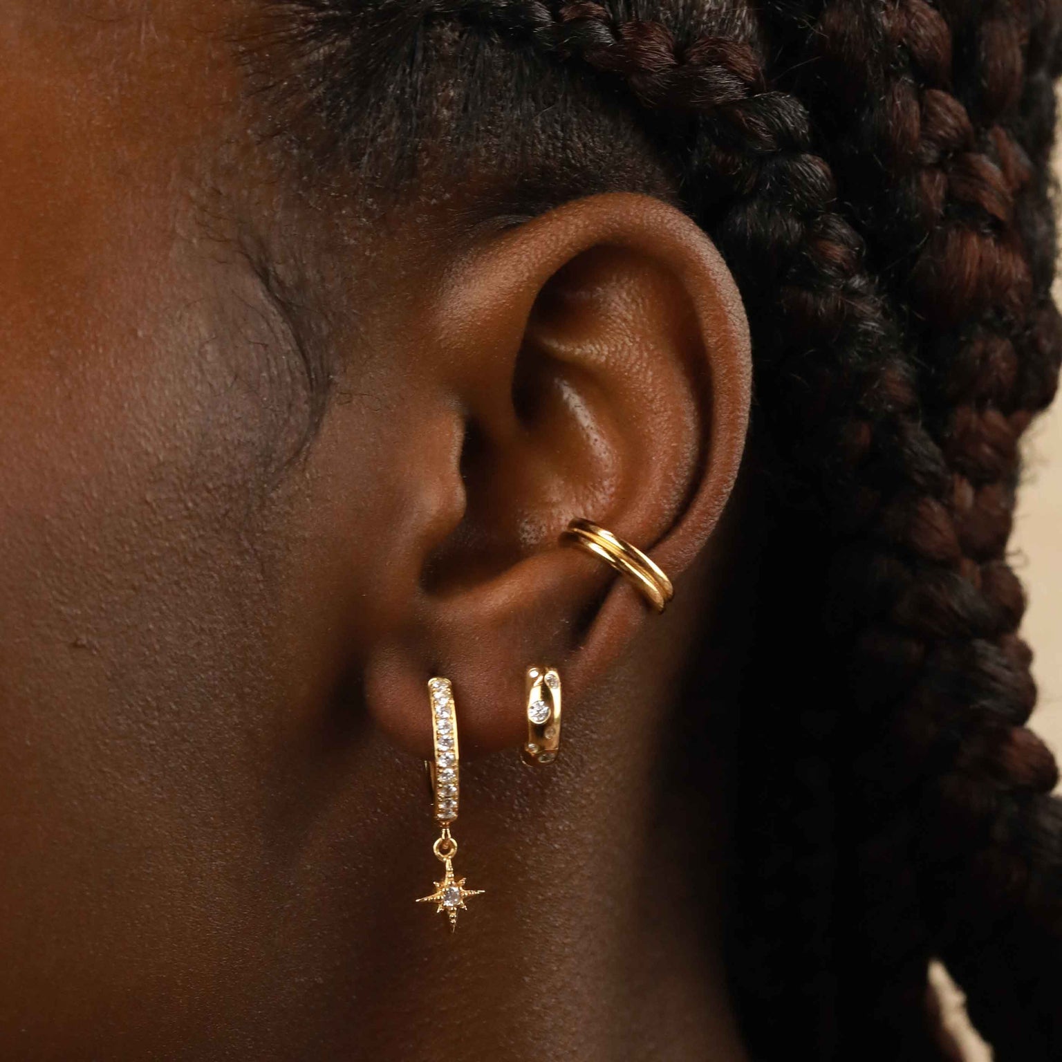 Crystal Star Hoops in Gold worn with other gold earrings