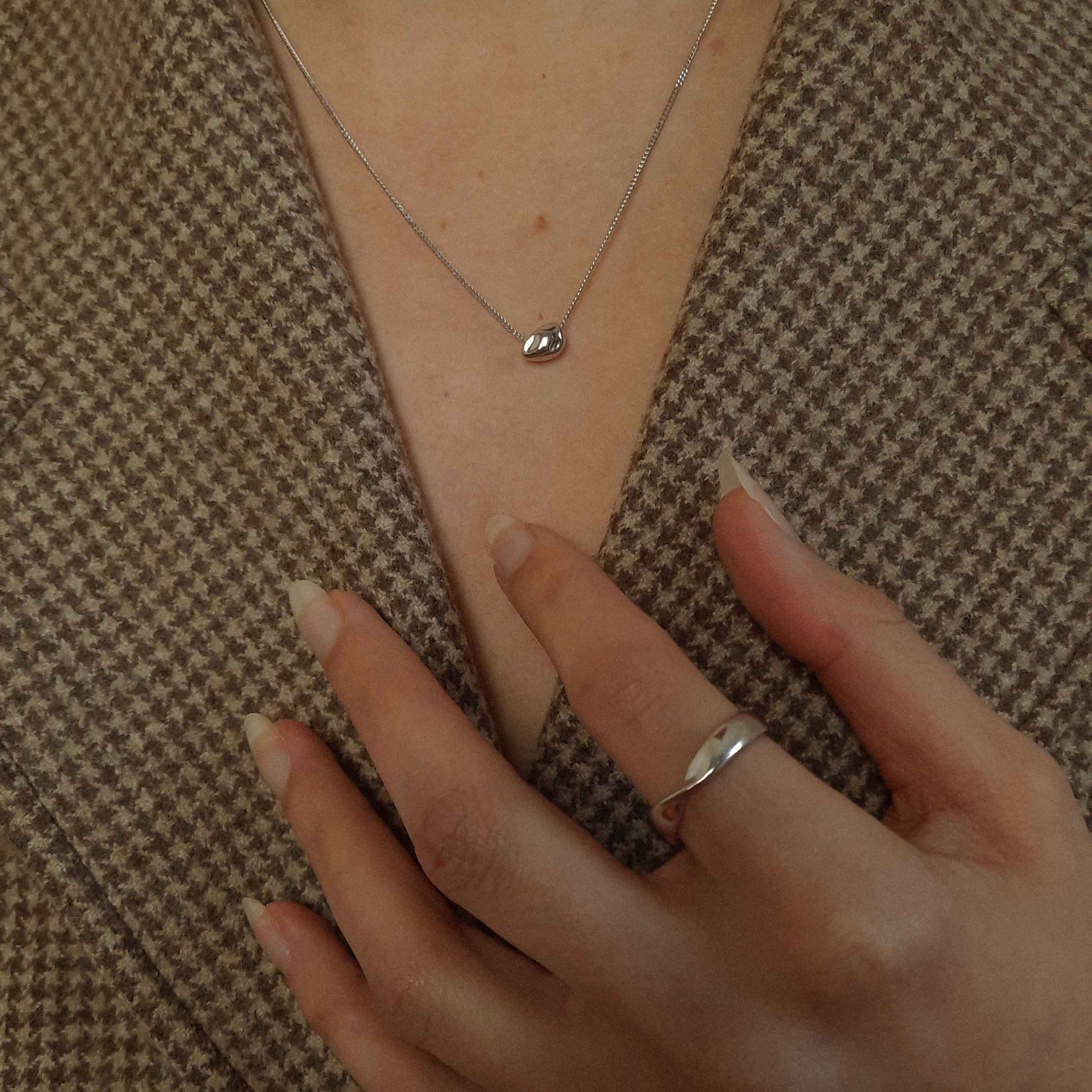 Elemental Ring in Silver worn with molten pendant necklace