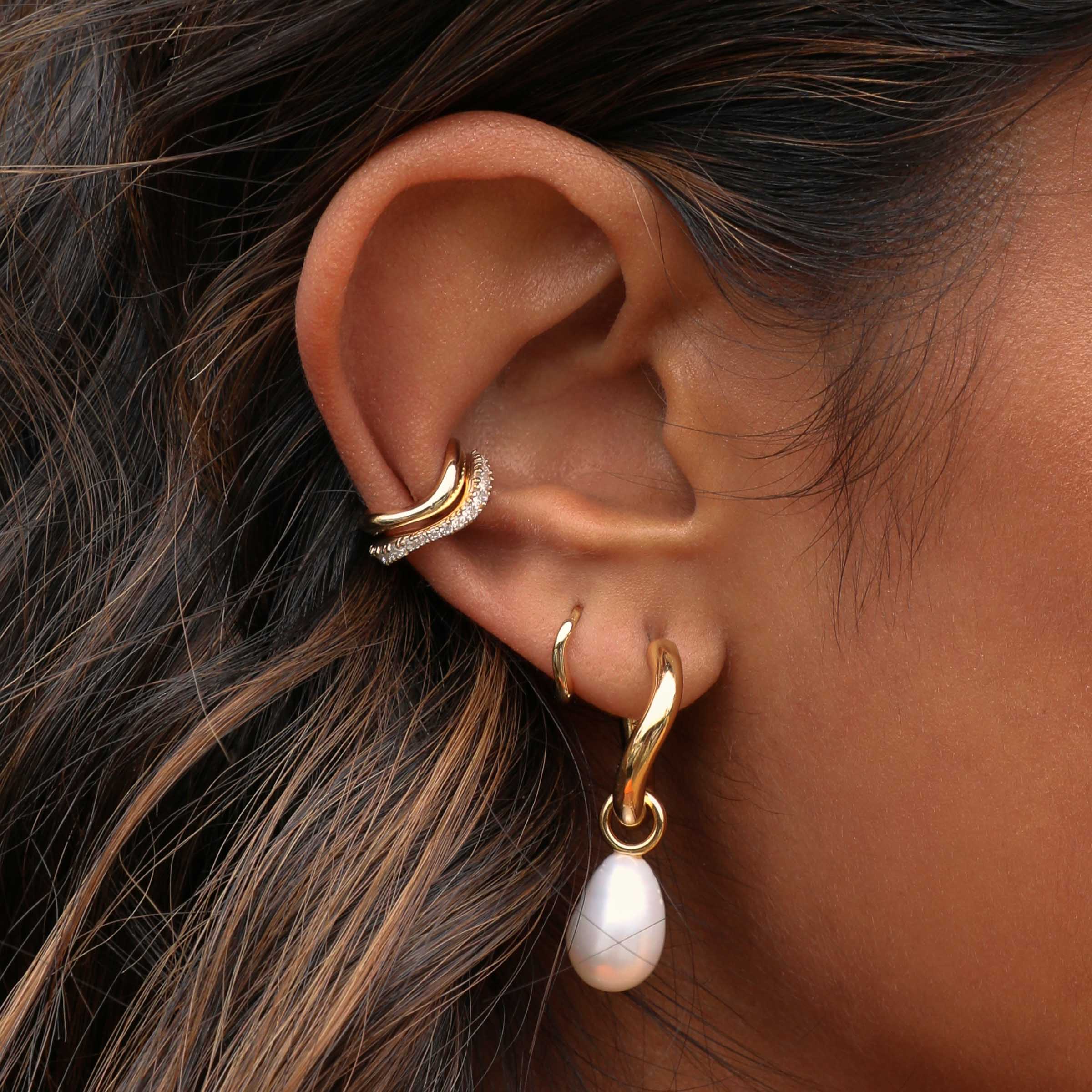 Wave Huggies in Gold worn with Serenity Pearl Hoop Earrings and wave ear cuffs