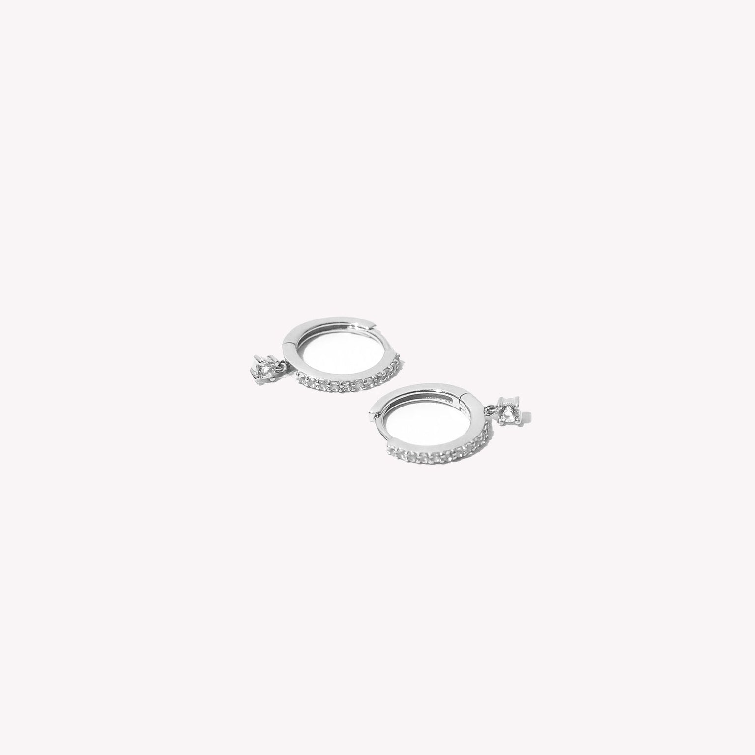 Topaz Charm Hoops in Solid White Gold flat lay