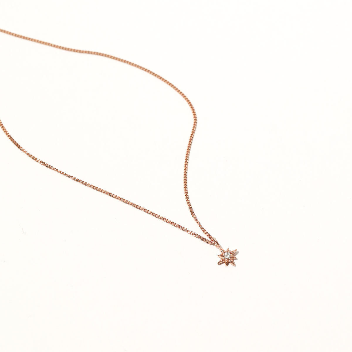 Twilight Star Pendant Necklace in Rose Gold flat lay