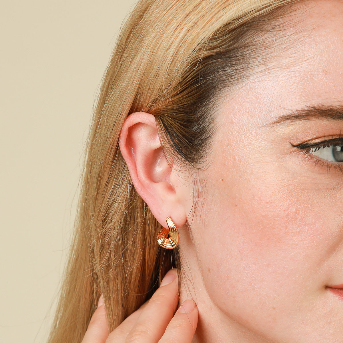 Molten Wave Small Hoops in Gold worn
