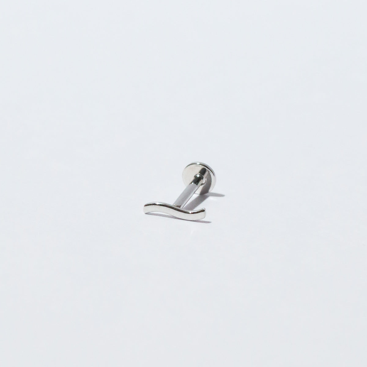 Wave Piercing Stud in Solid White Gold flat lay