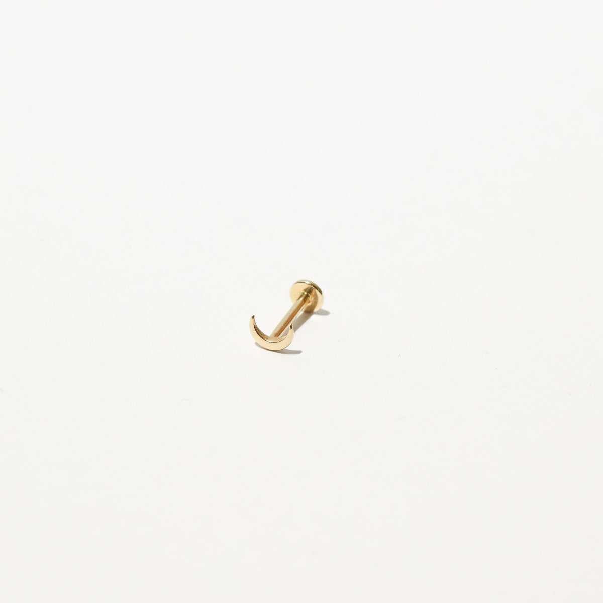Moon Piercing Stud in Solid Gold flat lay
