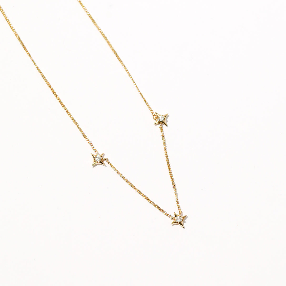 Cosmic Star Charm Necklace in Gold flat lay