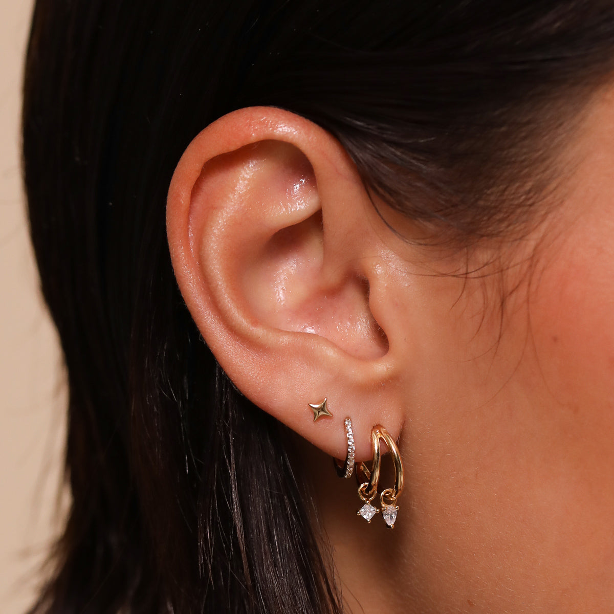 Celestial Crystal Huggies in Gold worn with other earrings