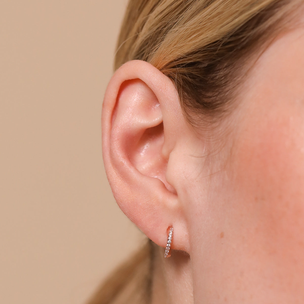 Orbit Crystal Huggies in Rose Gold worn