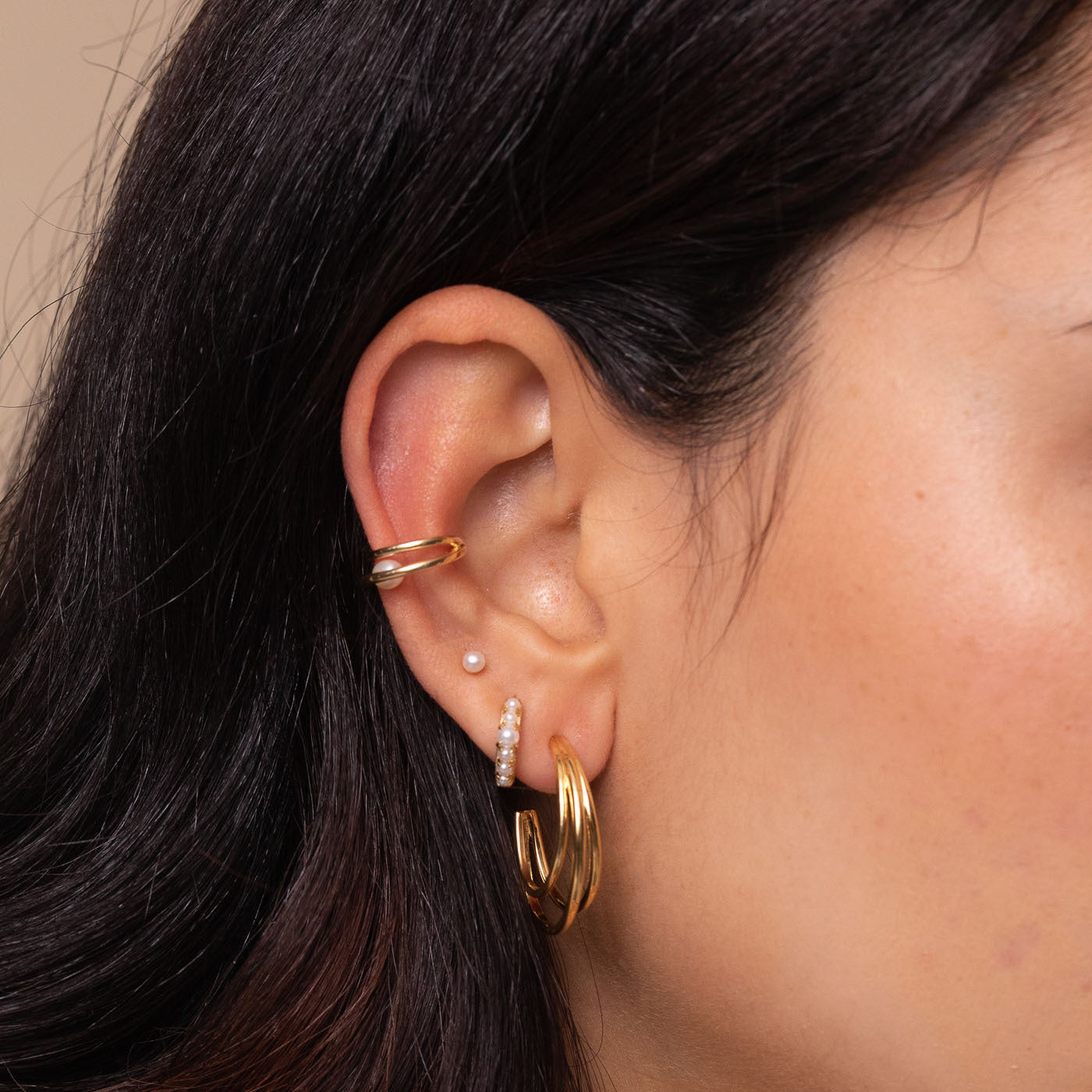 Radiant Pearl Stud Earrings in Gold worn with other earrings