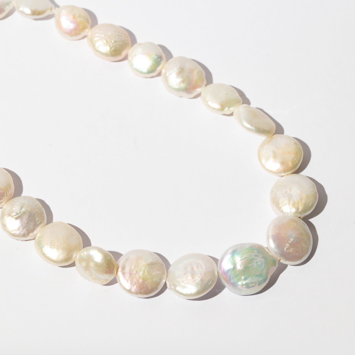 Opulent Pearl Necklace in Gold close up flat lay shot