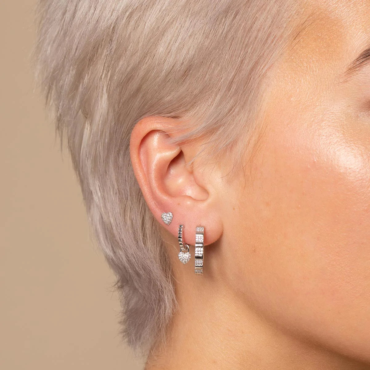 Pleated Crystal Hoops in Silver worn with other earrings