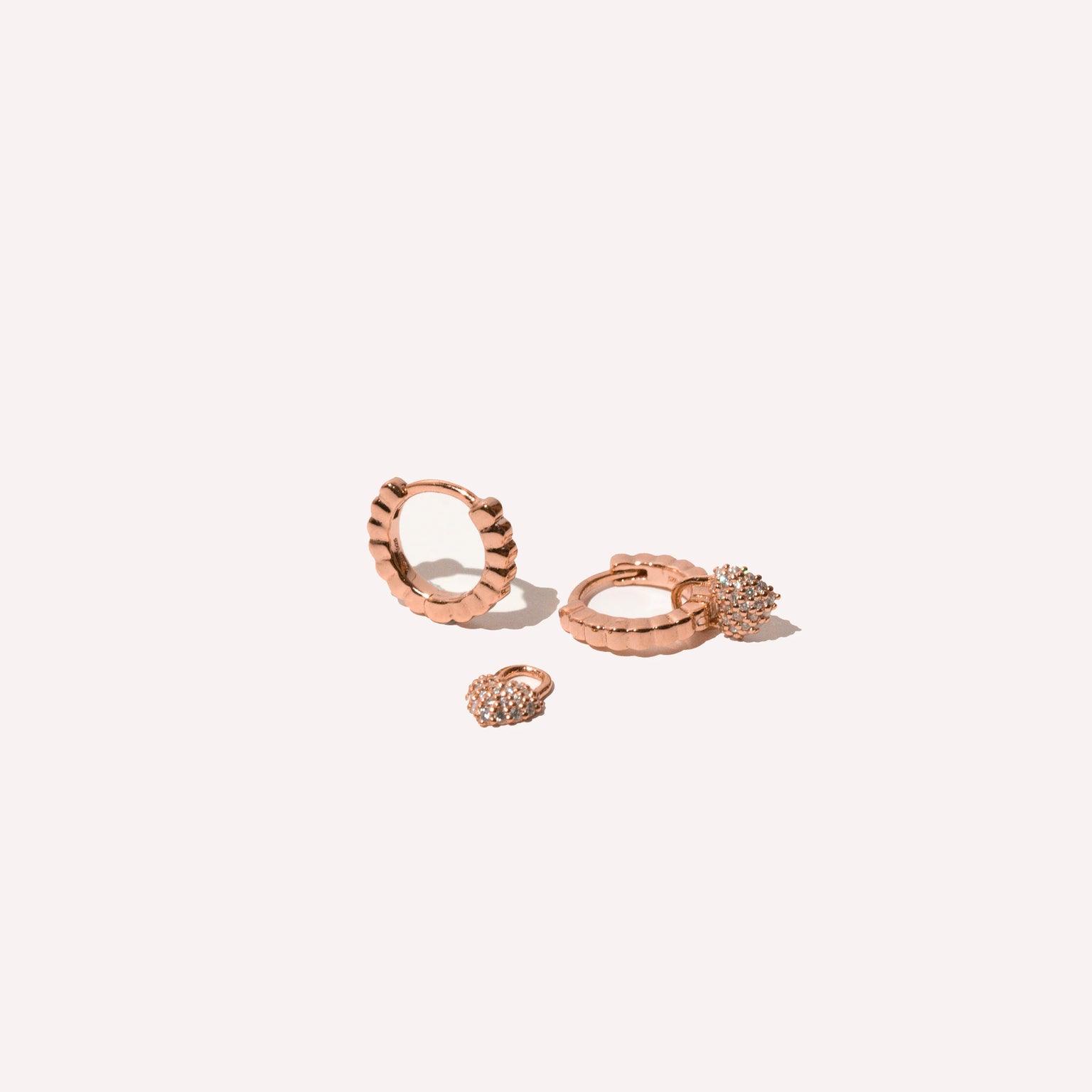 Heart Pave Charm Huggies in Rose Gold flat lay shot