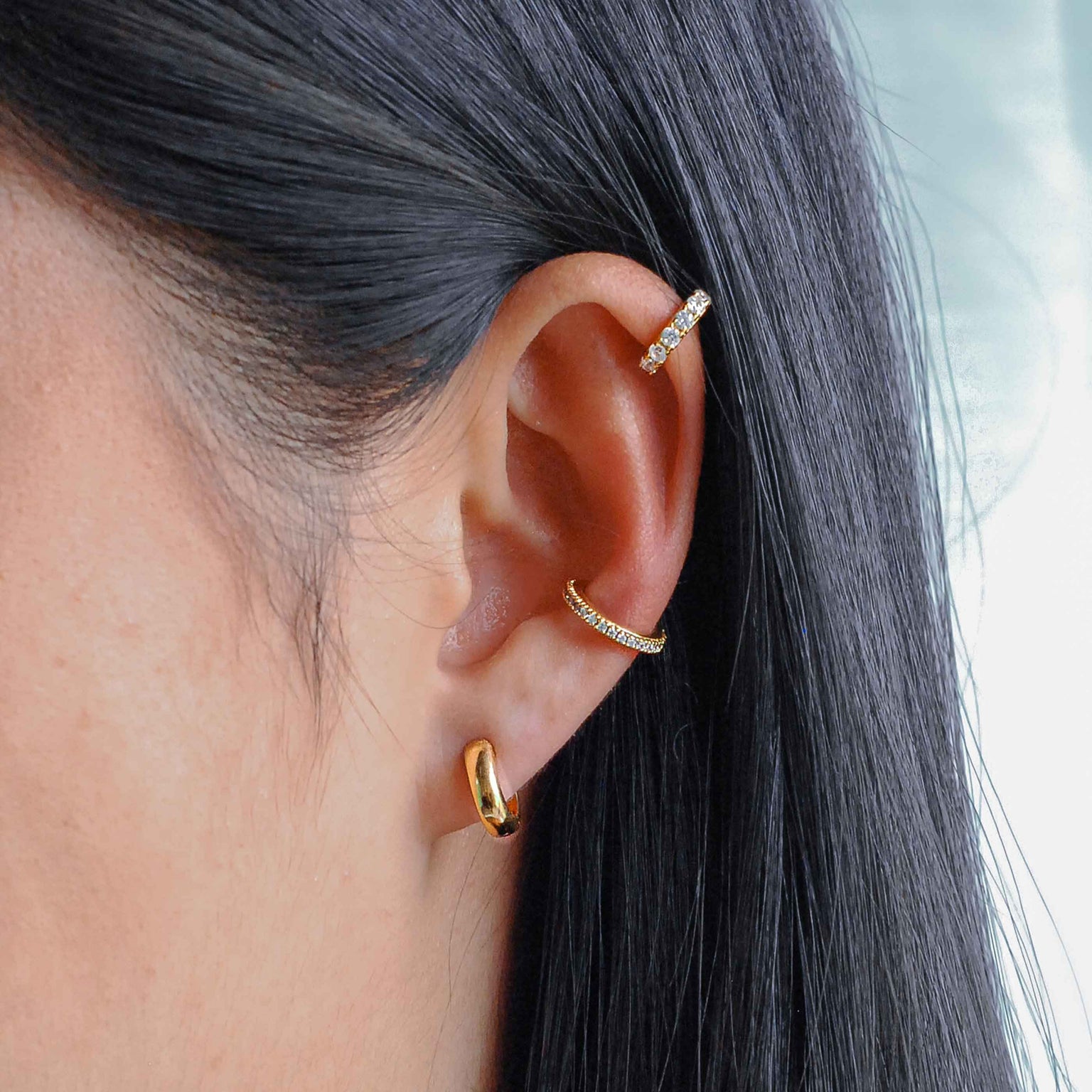 Crystal Ear Cuff in Gold worn with bold huggies in gold