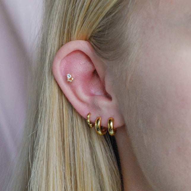 Bubble Clicker in Gold worn in third lobe piercing