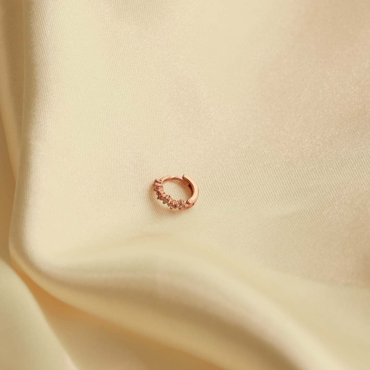 Flat lay image of Cluster Hoop 6.5mm in Rose Gold