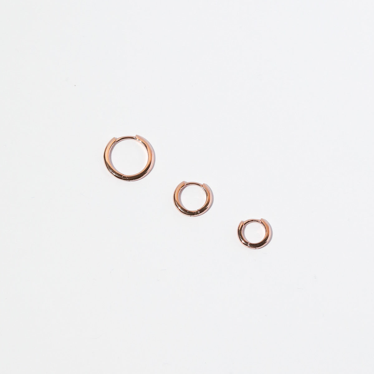 Essential Hoop in Rose Gold flat lay of all sizes