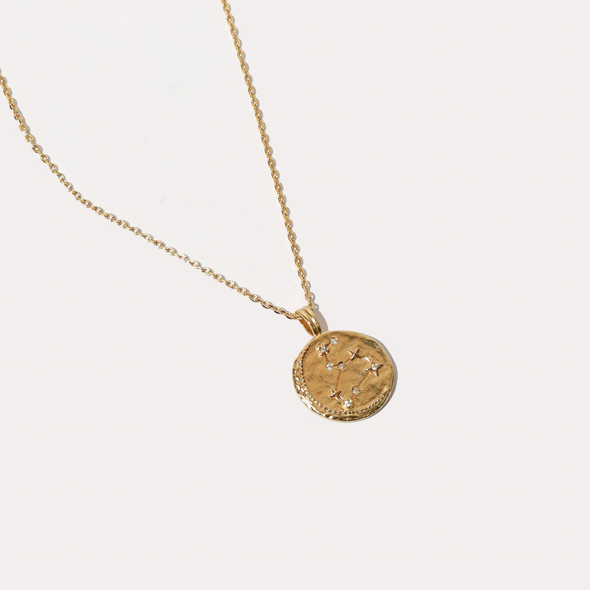 Close up shot of the front of the Leo Zodiac Pendant Necklace in Gold