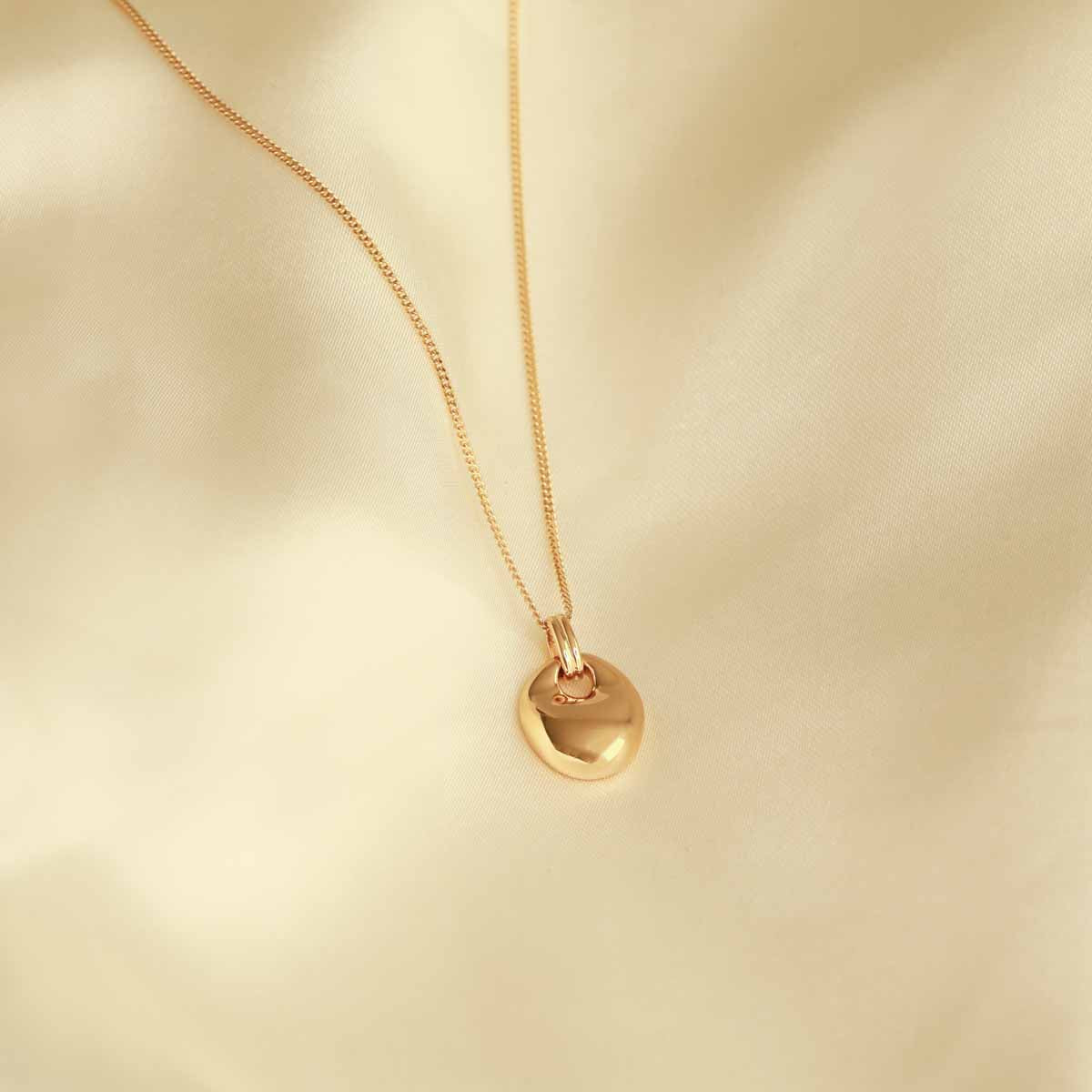 Flat lay shot of Essential Pendant Necklace in Gold