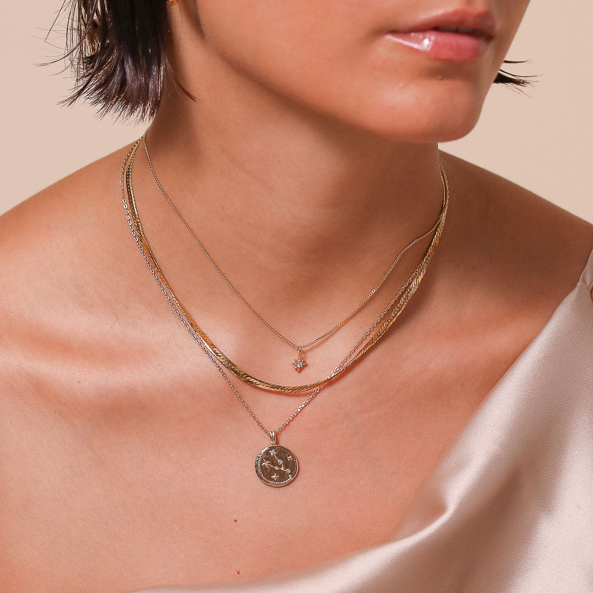 Taurus Zodiac Pendant Necklace in Gold worn layered with necklaces