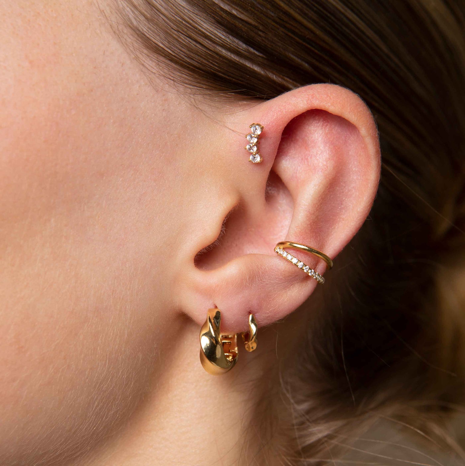 Elemental Hoops in Gold worn with elemental huggies and illusion crystal ear cuff