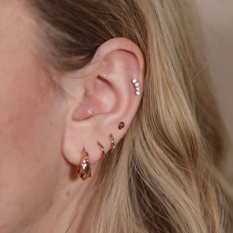 Elemental Huggies in Rose Gold worn with molten studs