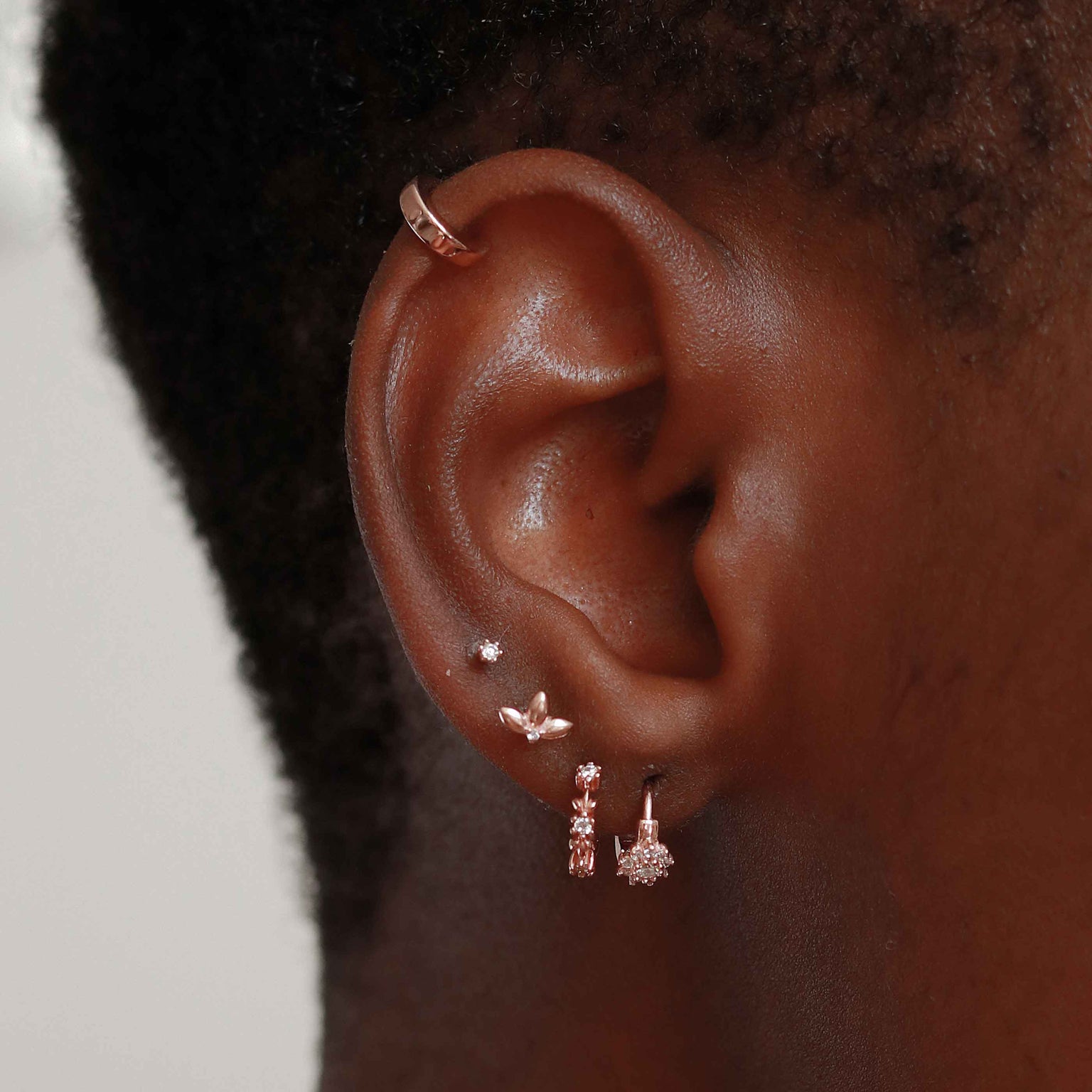 Flora Tiny Barbell in Rose Gold worn in fourth lobe piercing