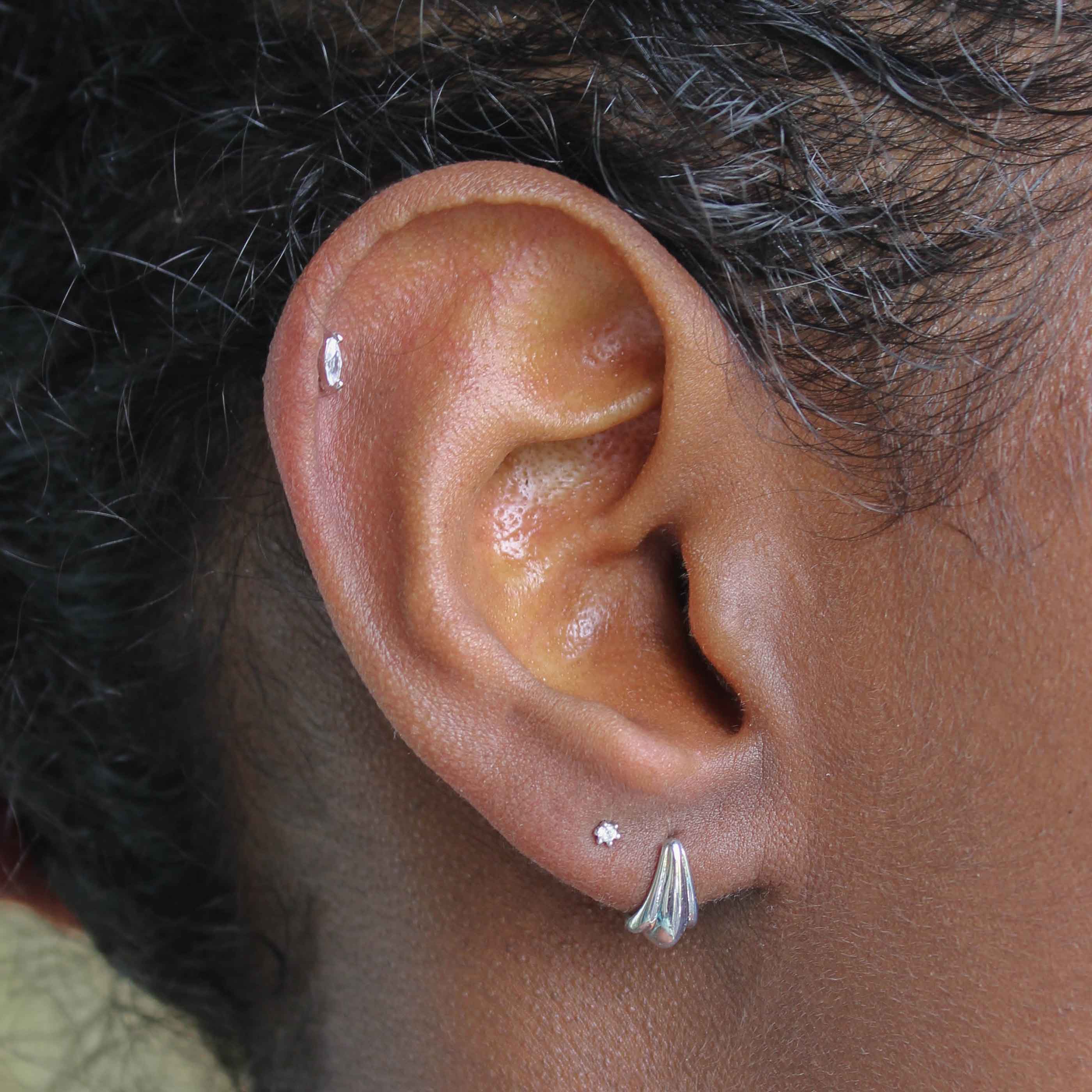 Flora Tiny Barbell in Silver worn in second lobe
