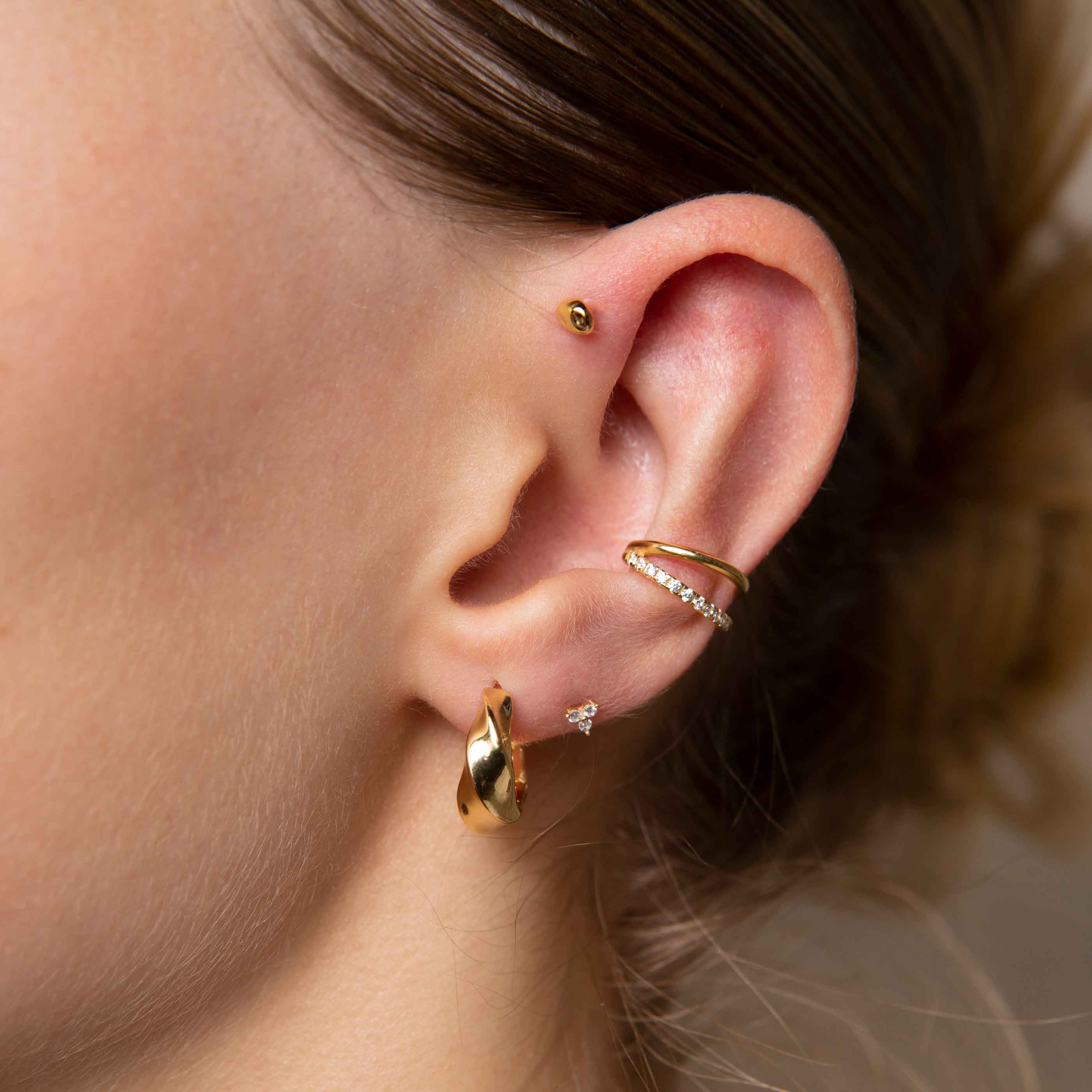 Triple Crystal Stud Earrings in Gold worn with elemental hoops