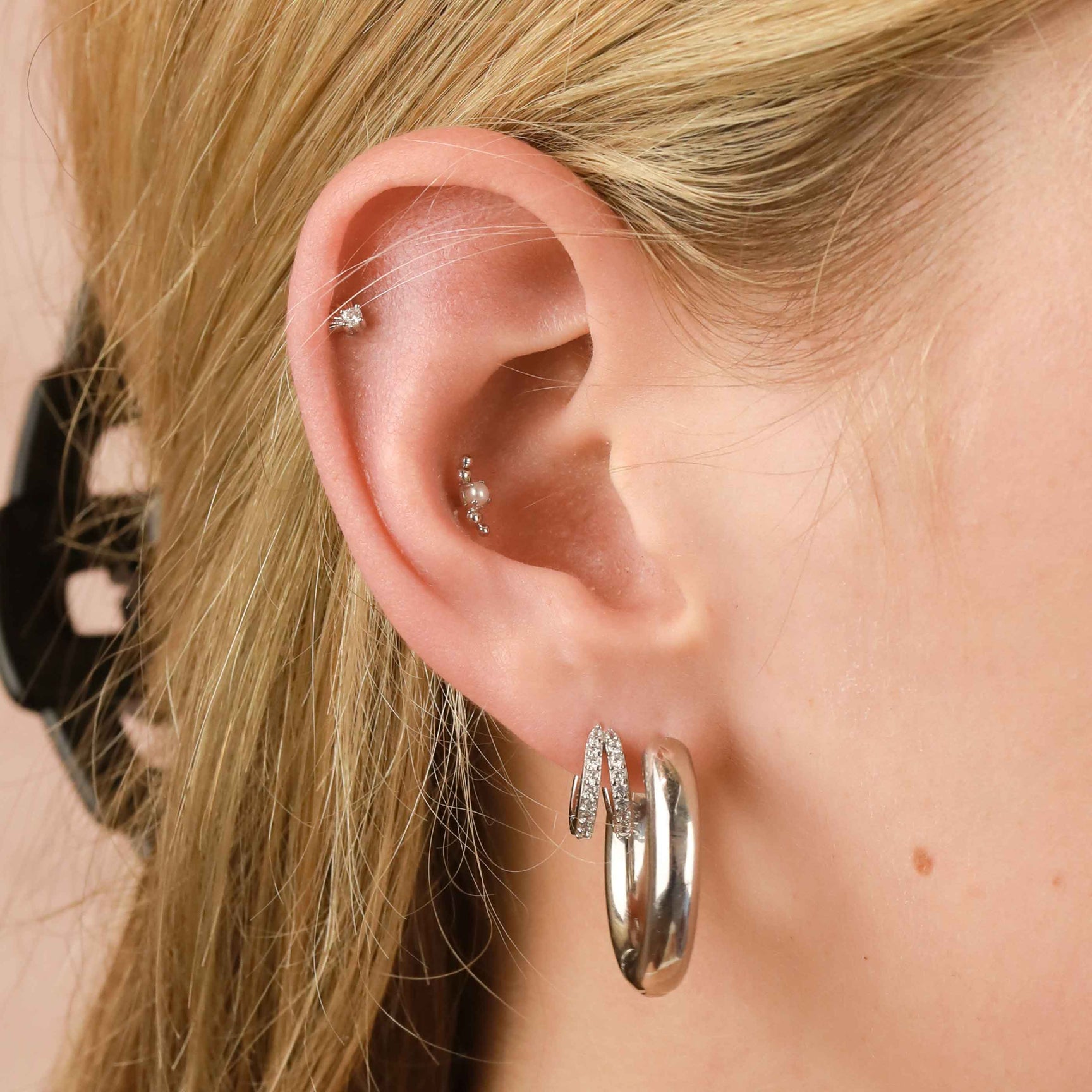 Illusion Crystal Huggies in Silver worn with Bold Hoops and a barbell