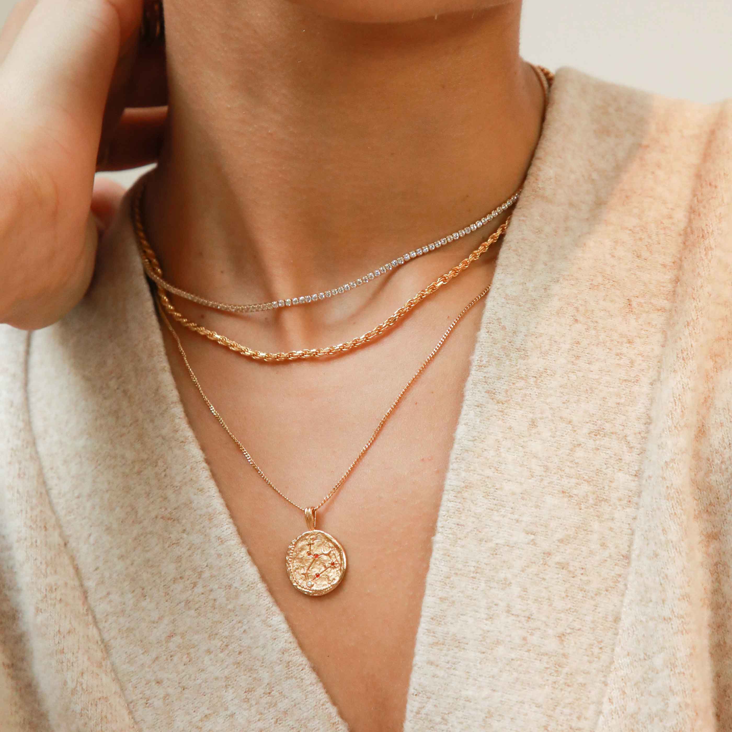 Tennis Chain Necklace in Gold layered with bold rope chain and zodiac pendant necklace