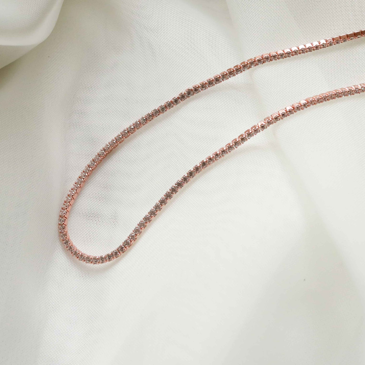 Flat lay shot of Tennis Chain Necklace in Rose Gold