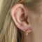 Flora Tiny Barbell in Gold worn in outer conch piercing